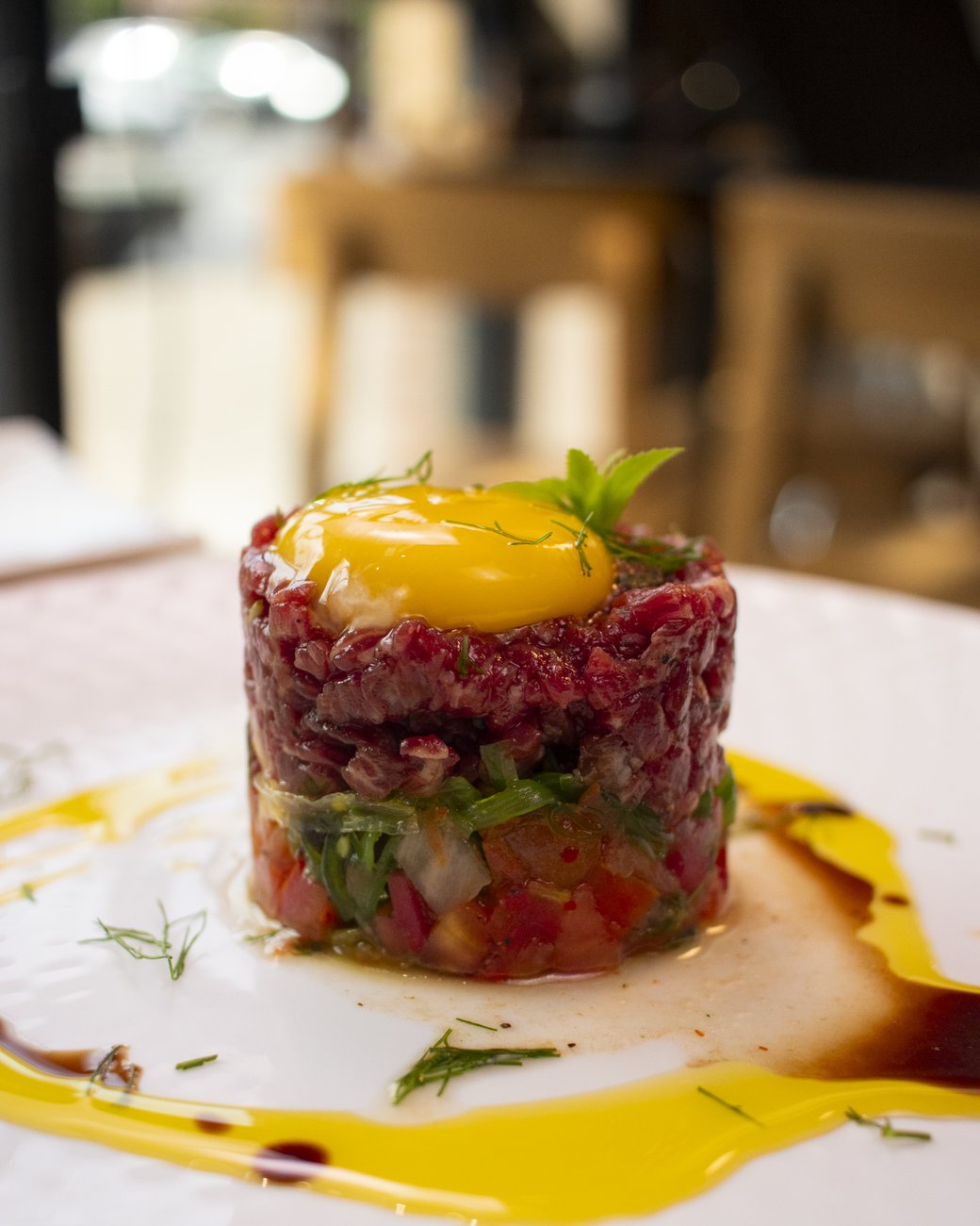 Hand-cut beef tartare with egg yolk at ARANAYA in Houston